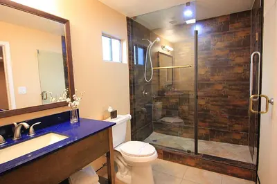 a bathroom with a shower and a toilet and a sink at Colony Inn in North Hollywood