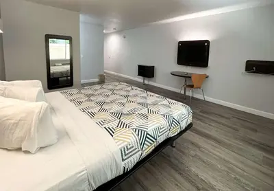 a bedroom with a bed and a tv on the wall at Motel 6-Anaheim, CA in Anaheim