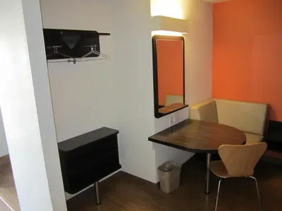 a small room with a table and a mirror at Motel 6-Anaheim, CA in Anaheim