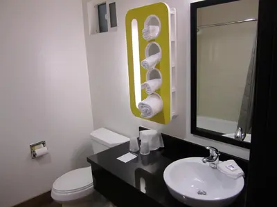 a bathroom with a sink and a toilet and a mirror at Motel 6-Anaheim, CA in Anaheim
