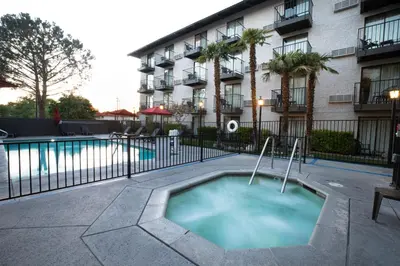 a swimming pool in front of a building at Oxnard Inn Lancaster in Lancaster