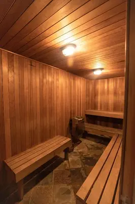 a sauna with wooden walls and benches in a room at Oxnard Inn Lancaster in Lancaster