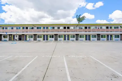 an empty parking lot in front of a building at Exclusivo Inn and Suites in Lakewood