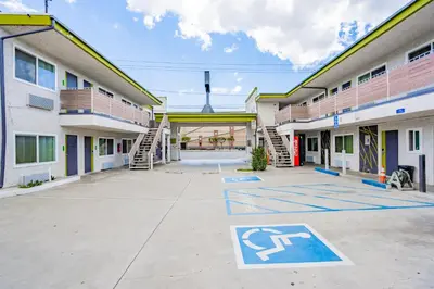 an empty parking lot in front of a building at Exclusivo Inn and Suites in Lakewood