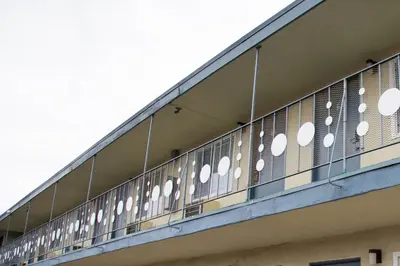 a building with white circles on the side of it at Sahara Motel in Anaheim