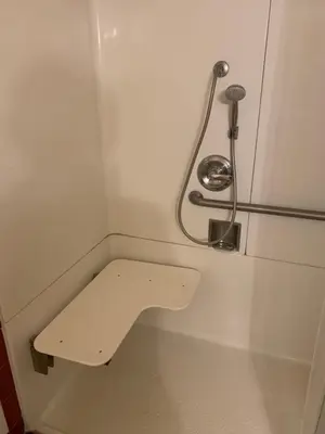a toilet in a train room with a handicaped seat at Grand Inn\u8ca1\u795e\u5ba2\u68e7 in Monterey Park