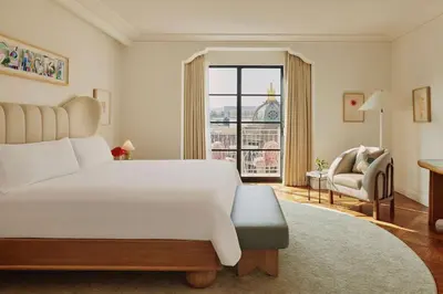 a bedroom with a large white bed and a window at The Maybourne Beverly Hills, Maybourne in Los Angeles