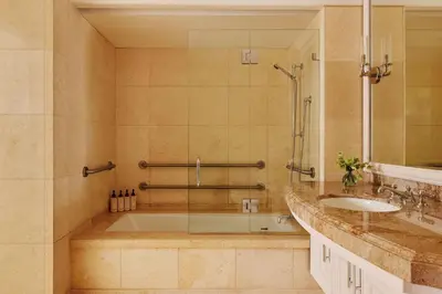 a bathroom with a tub and a sink at The Maybourne Beverly Hills, Maybourne in Los Angeles