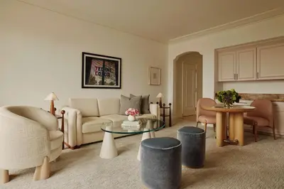 a living room with a couch and a table at The Maybourne Beverly Hills, Maybourne in Los Angeles