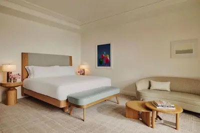 a hotel room with a bed and a couch at The Maybourne Beverly Hills, Maybourne in Los Angeles