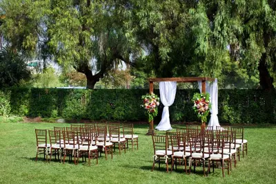a row of chairs with a wedding altar in a field at Sheraton Fairplex Suites & Conference Center in Pomona