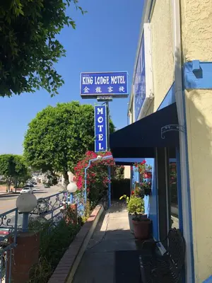 a street sign for a living house motel on a sidewalk at King Lodge Motel in Monterey Park