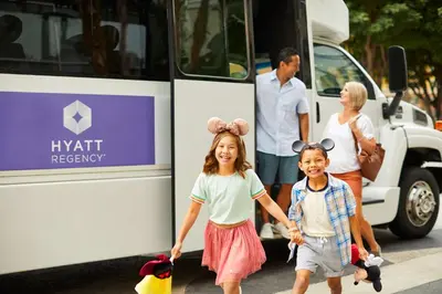 two children holding hands as they exit a bus at Hyatt Regency Orange County in Anaheim