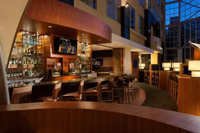 a restaurant with a bar with chairs and tables at Hyatt Regency Orange County in Anaheim