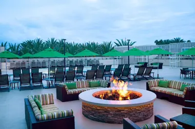 a patio with a fire pit and tables and chairs at Hyatt Regency Orange County in Anaheim