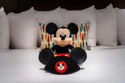 a stuffed mickey mouse sitting on a bed at Alpine Inn near Convention Center and the Park in Anaheim