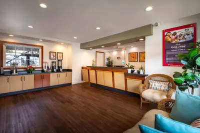 a salon with a waiting room with a counter and chairs at Alpine Inn near Convention Center and the Park in Anaheim