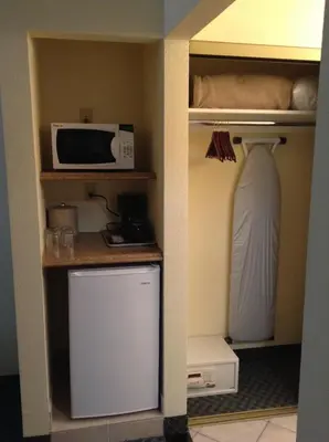 a kitchen with a microwave and a refrigerator at Best Inn & Suites in Anaheim