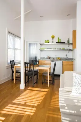 a kitchen and dining room with a table and chairs at Venice Suites in Los Angeles