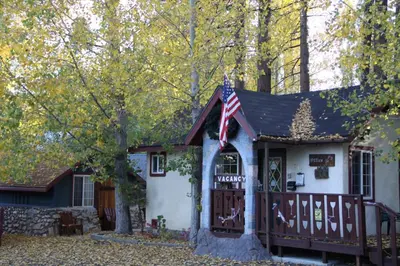 a small house with an american flag on it at Castle Wood Theme Cottages- COUPLES ONLY in Big Bear Lake