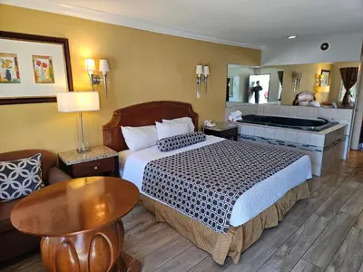 a hotel room with a bed and a bathroom at Fullerton Inn in Fullerton