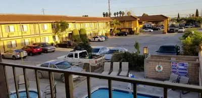 a view of a parking lot with cars and buildings at Fullerton Inn in Fullerton