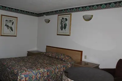a hotel room with a bed and two pictures on the wall at Best Whittier Inn in Whittier