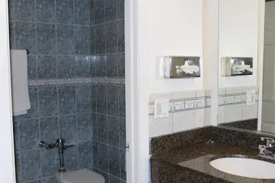 a bathroom with a toilet and a sink at Best Whittier Inn in Whittier