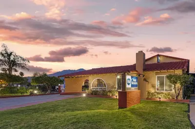 a building with a sunset in the background at Best Western La Posada Motel in Fillmore