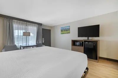 a hotel room with a bed and a flat screen tv at Best Western La Posada Motel in Fillmore