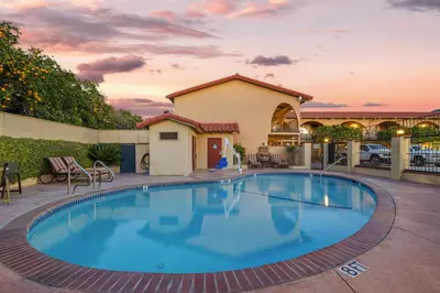 a large swimming pool with chairs and a building at Best Western La Posada Motel in Fillmore