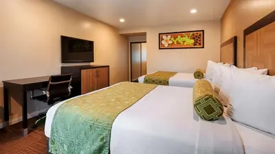 a hotel room with two beds and a desk at Best Western Plus Glendale in Glendale