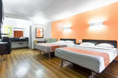 a hotel room with two beds and a television at Motel 6-Long Beach, CA - International City in Long Beach
