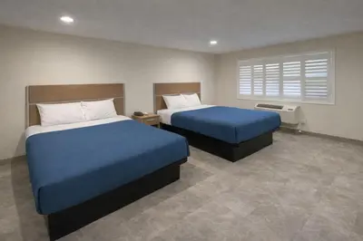 a hotel room with two beds and a window at Super 8 by Wyndham Bakersfield CA in Bakersfield
