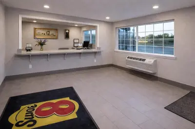 an empty waiting room with a window and a radiator at Super 8 by Wyndham Bakersfield CA in Bakersfield