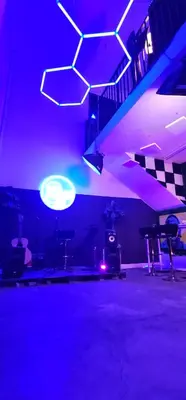 a dark room with purple lights and a stage at Artist Housing - Downtown in Los Angeles