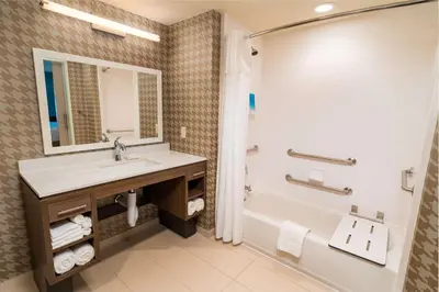 a bathroom with a sink and a tub and a shower at Home2 Suites Bakersfield in Bakersfield