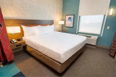 a hotel room with a large bed and a window at Home2 Suites Bakersfield in Bakersfield