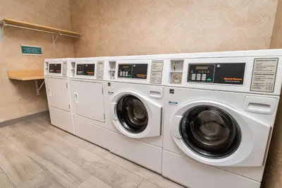 two washing machines are in a laundry room at Home2 Suites Bakersfield in Bakersfield