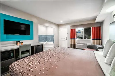 a large bedroom with a bed and a television at Rodeway Inn South Gate - Los Angeles South in South Gate