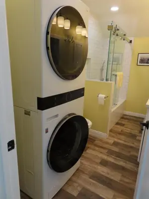 a bathroom with a toilet with a mirror on the wall at Hill Street Cottage in Los Angeles
