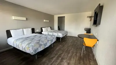 a hotel room with two beds and a desk at Motel 6-Delano, CA in Delano
