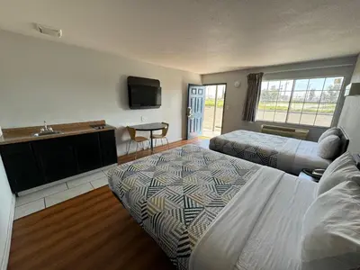 a hotel room with two beds and a sink at Motel 6-Delano, CA in Delano