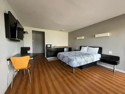 a bedroom with a bed and a desk and a television at Motel 6-Delano, CA in Delano