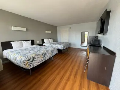 a hotel room with two beds and a flat screen tv at Motel 6-Delano, CA in Delano