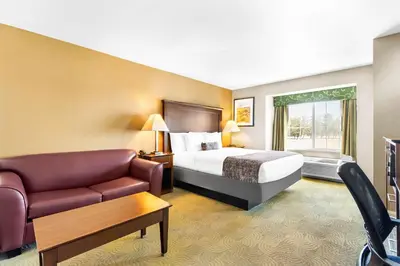 a hotel room with a bed and a couch at Best Western California City Inn & Suites in California City