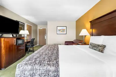a hotel room with a large bed and a flat screen tv at Best Western California City Inn & Suites in California City