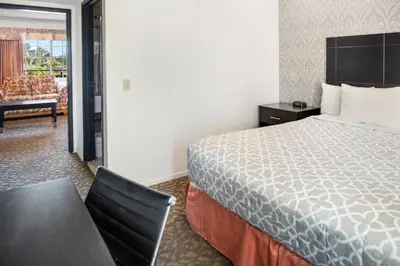 a hotel room with a bed and a desk and a chair at Glendale Hotel in Glendale