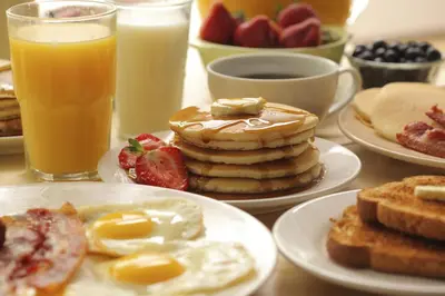 a table topped with plates of breakfast foods and drinks at Ayres Hotel Orange in Anaheim