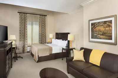 a hotel room with a bed and a couch at Ayres Hotel Orange in Anaheim